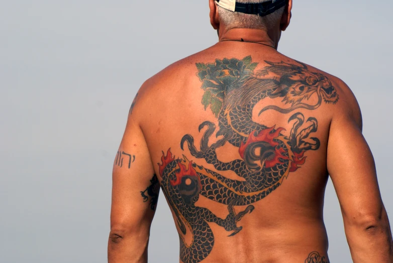 a man with a dragon tattoo on his back