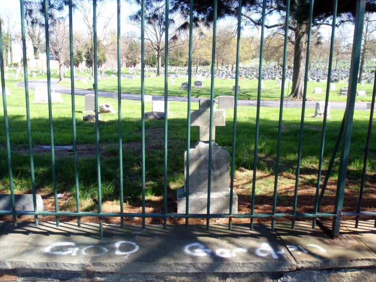 a gate opens to the headstone of a tombstone