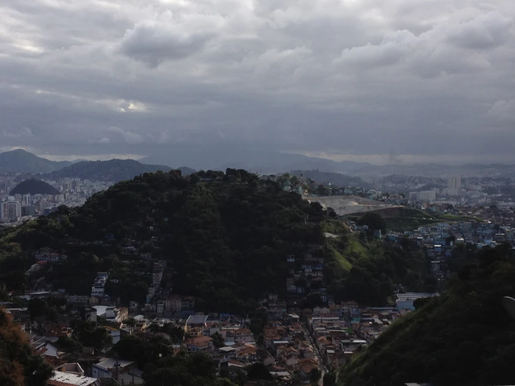 clouds cover the skyline as the city sits on top of the hill