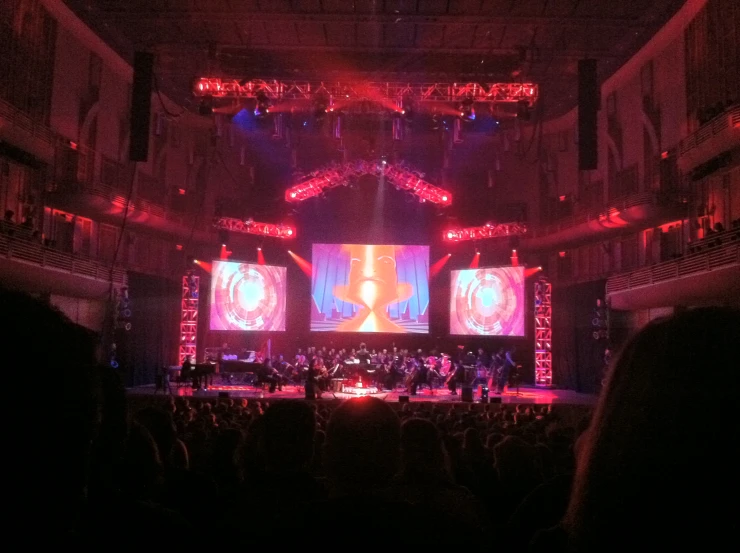 large indoor concert with music displayed on stage