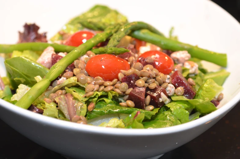 a salad in a white bowl on top of a table