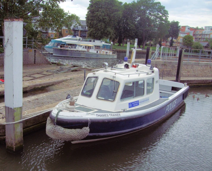 a small tug boat docked at a marina