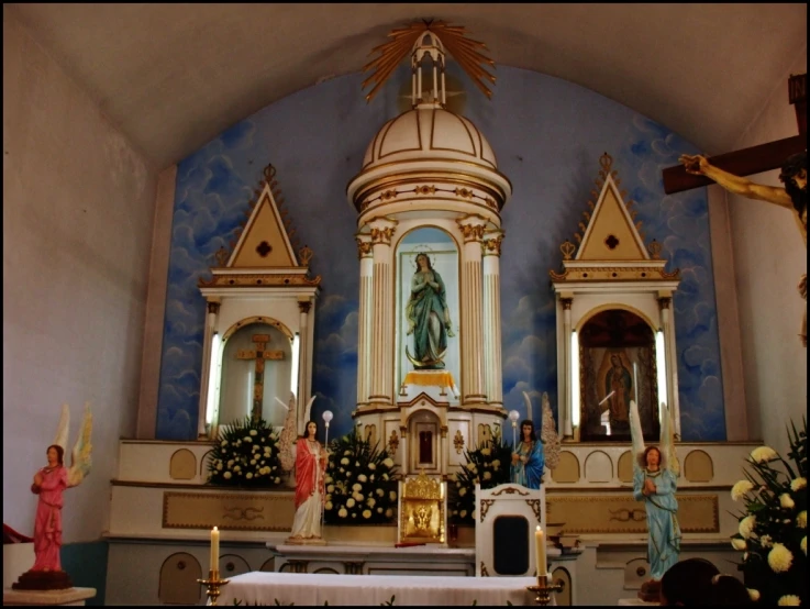 a cathedral decorated with flowers and statues of religious people