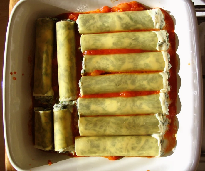 a container filled with food wrapped in some kind of sauce