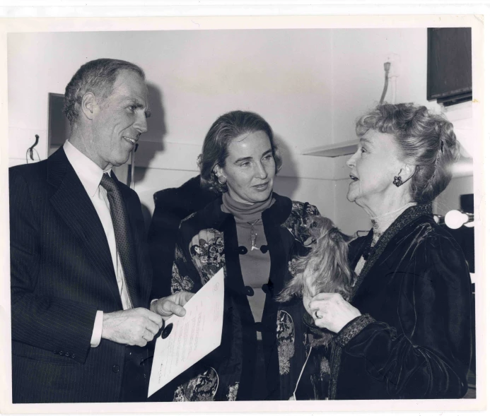 an older man standing next to a woman