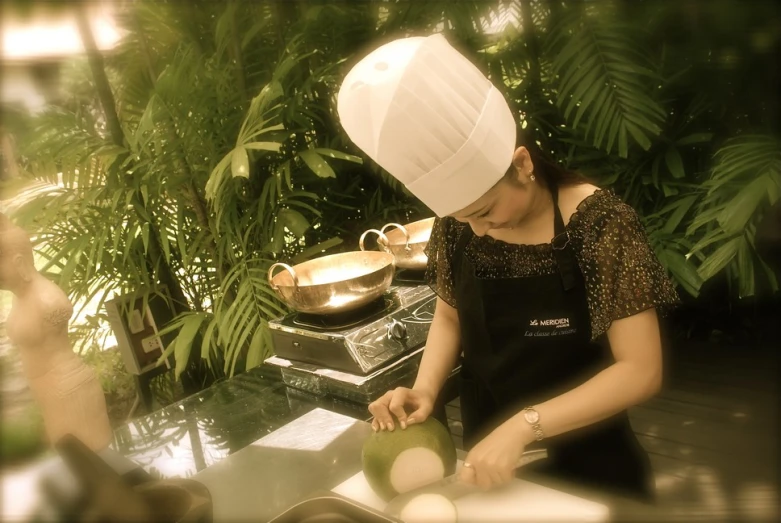 a woman wearing a chef hat and preparing food