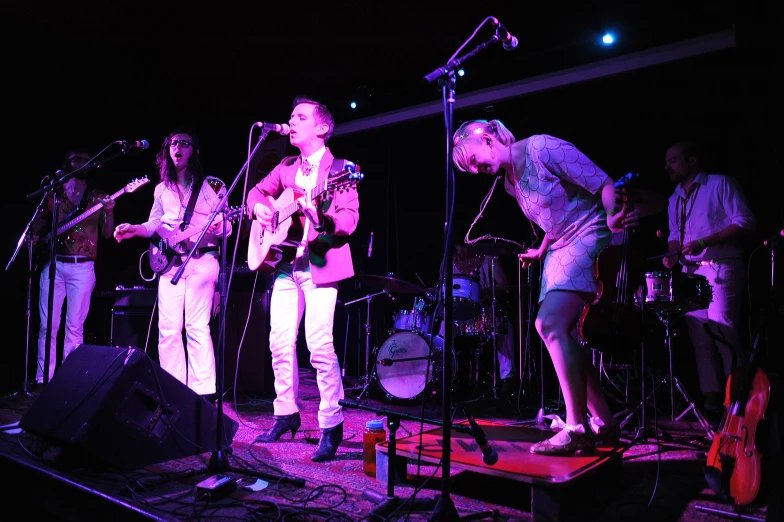 a group of young people standing next to each other on stage