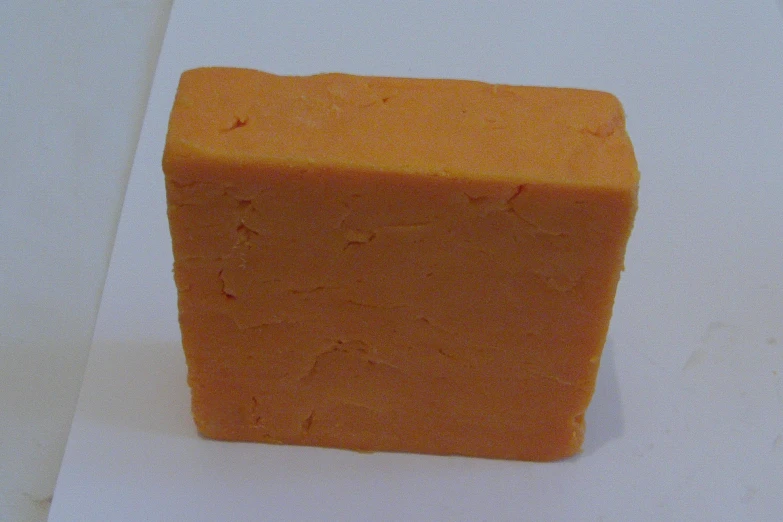 the cube of cheese is made of bright orange colored bread