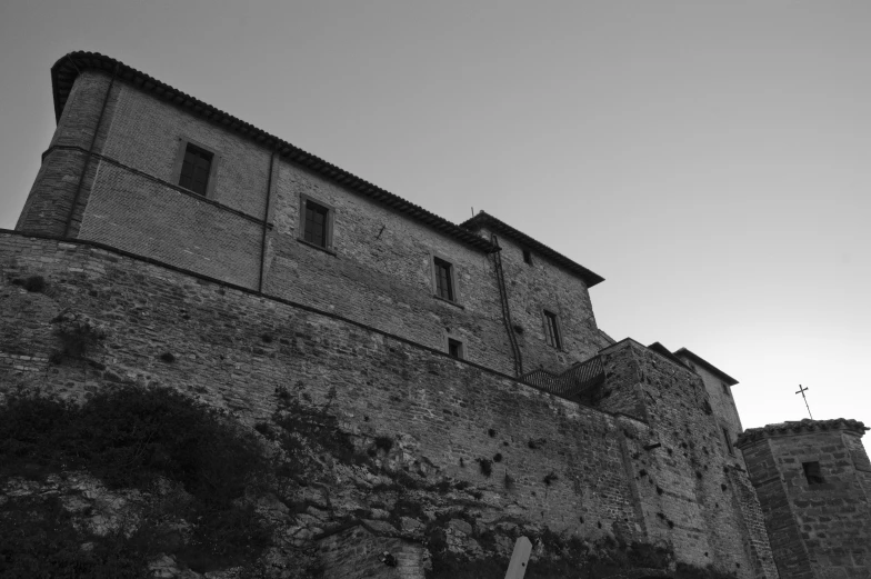 a stone wall that has buildings in the background