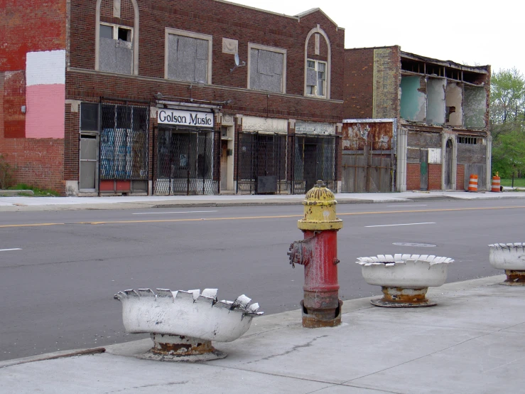 a fire hydrant on a side walk with bowls placed beside it