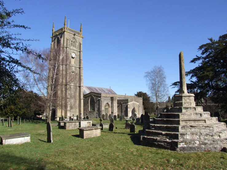 a church and cemetery with a steeple in the background