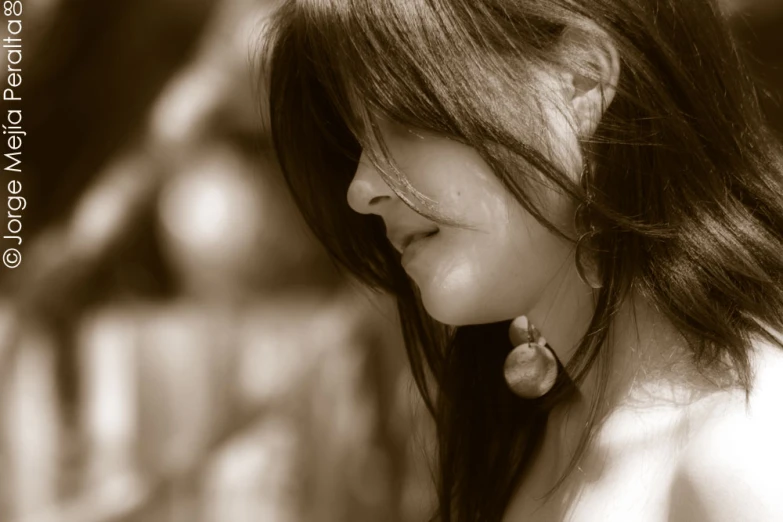 a young woman smiling while holding a cell phone