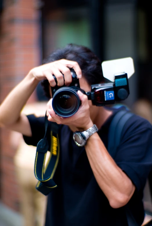 a man holds a camera to take pictures