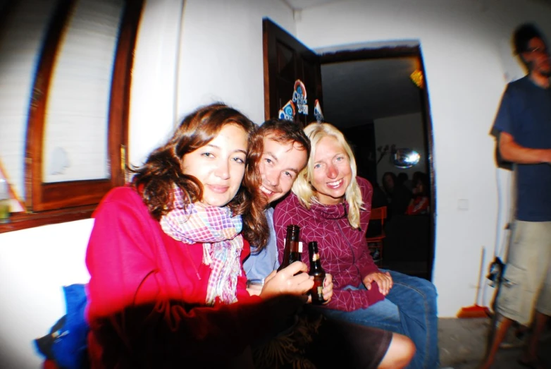 a group of young women pose together with a cell phone