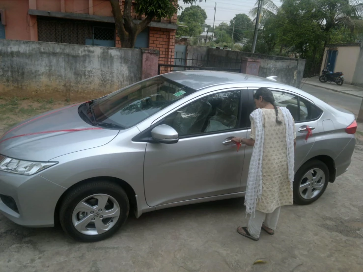 an image of a woman standing by a car