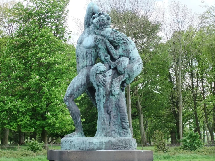 a large statue sits in the middle of a field