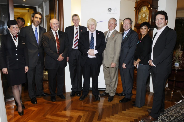 a group of men standing together on a wooden floor