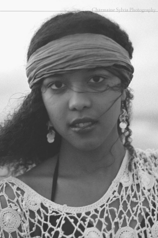 a woman with big eyes wearing a headband