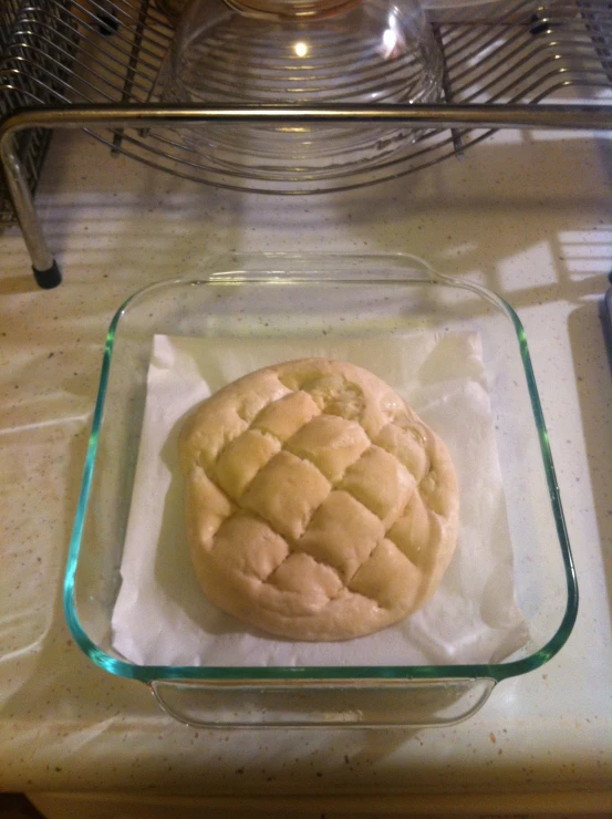 bread sitting in a glass container on top of a counter