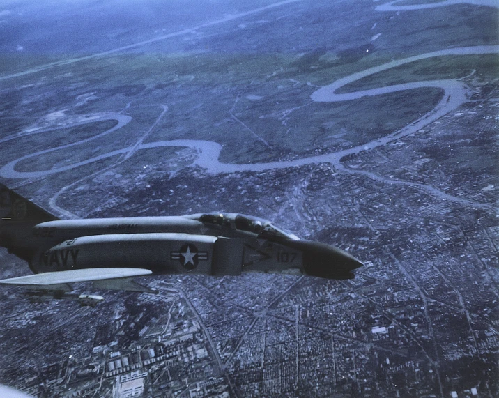 two fighter jets in the sky above an urban area