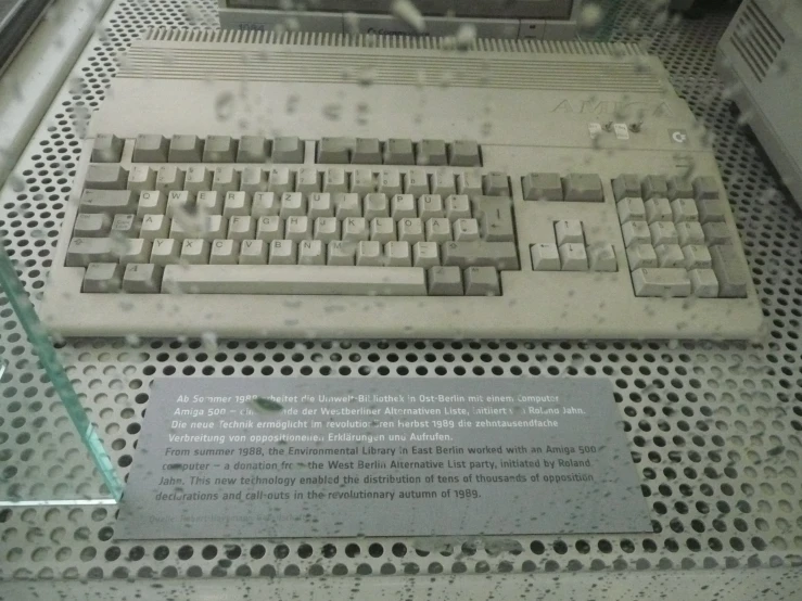 a small computer keyboard sitting on top of a metal structure
