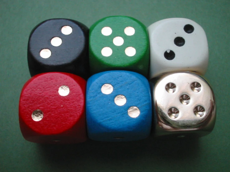 four different colored dices arranged in the shape of six with holes