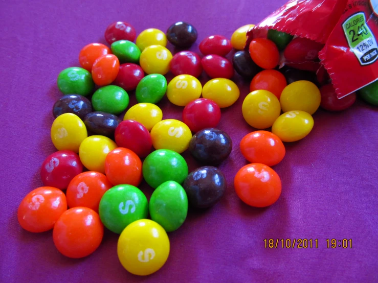 various colors of candy on a purple tablecloth