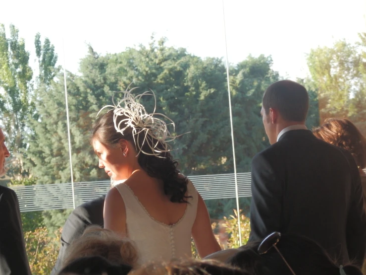 a woman in a wedding gown with a messy hairdo is walking