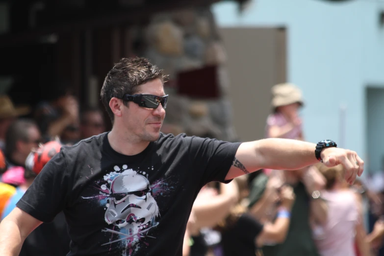 a man holding a frisbee in front of a crowd