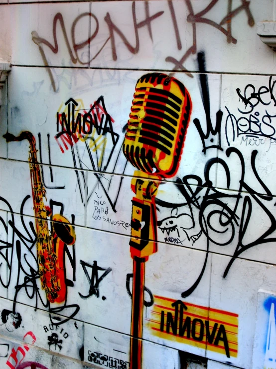 graffiti and old microphones are all over a wall