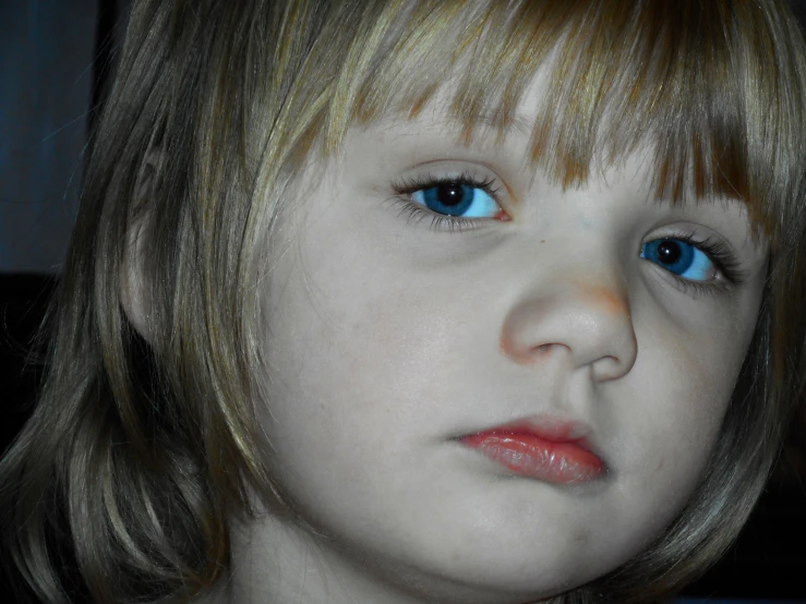 young child with bright blue eyes and blonde hair