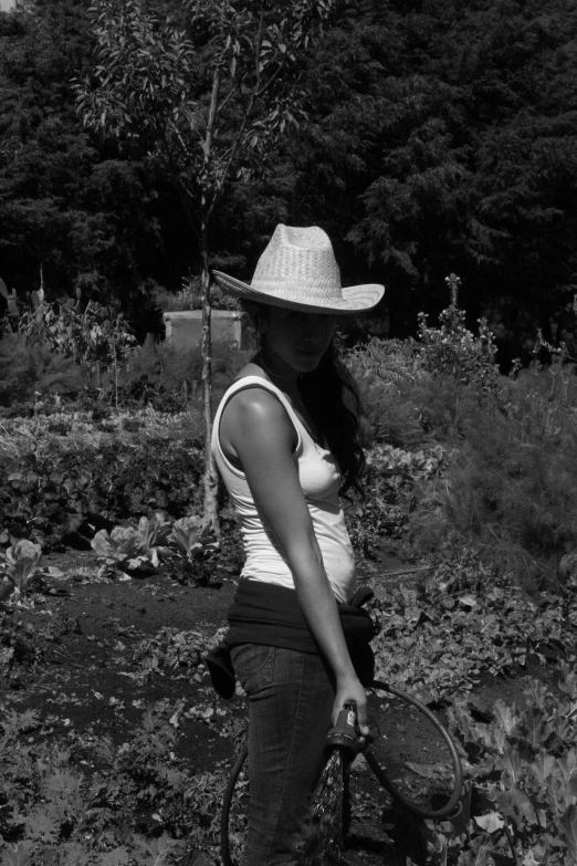 a black and white po of a woman wearing a hat