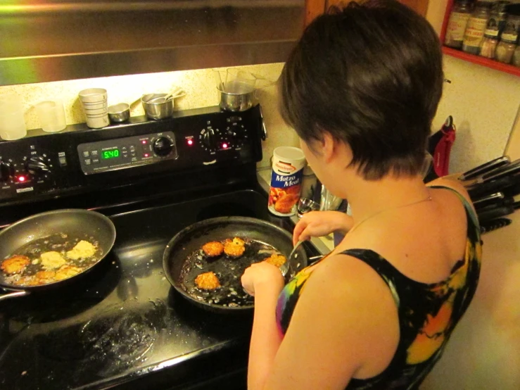 a woman is cooking in a set on the stove