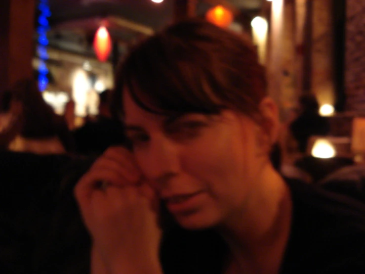 a woman talking on her cell phone in a dark room