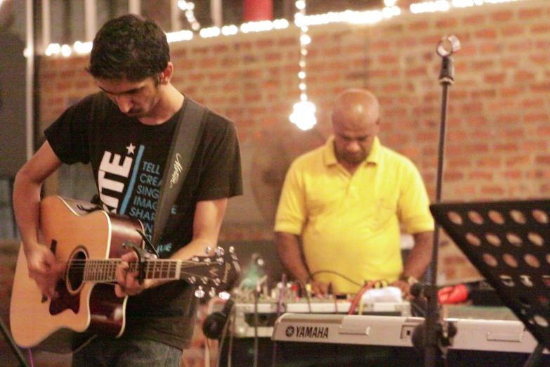 two men are playing the music at a band