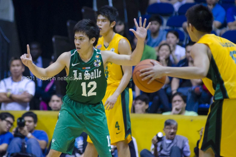 a man is reaching for the basketball during a game