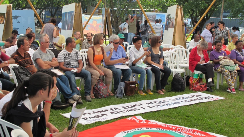 people seated in chairs watching and presenting