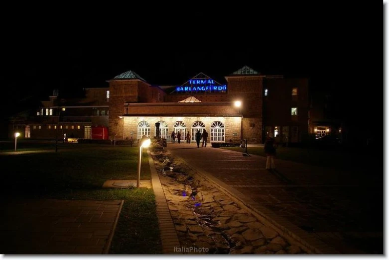 a big building in the night with some lights on