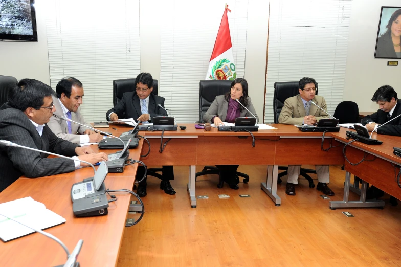 a group of people sitting around a conference table