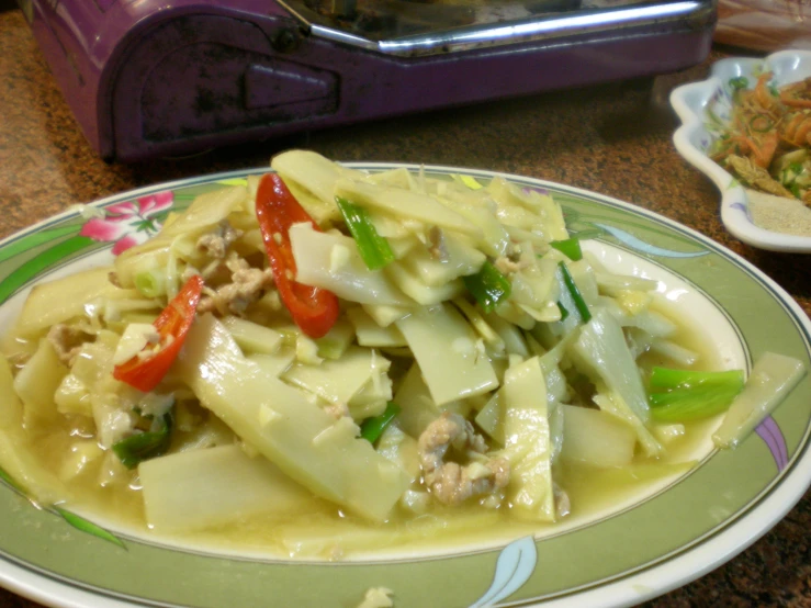 a plate of chinese vegetables sitting on the counter