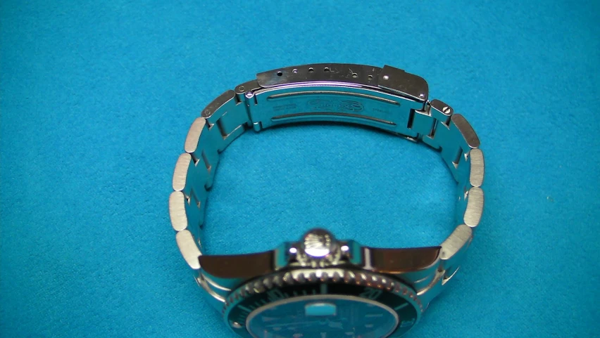 a blue metal watch with an automatic date clock on it
