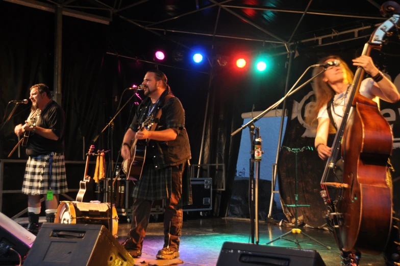 musicians at outdoor concert with light colored lighting