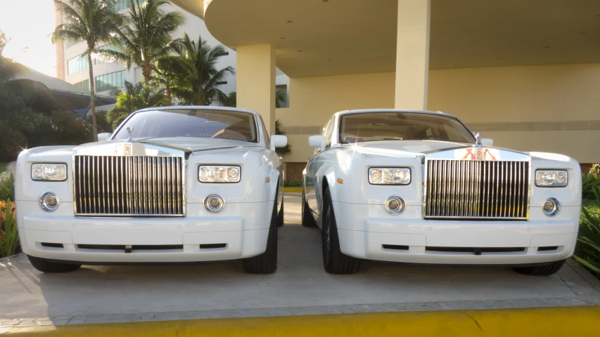 a white limousine sitting in front of a car