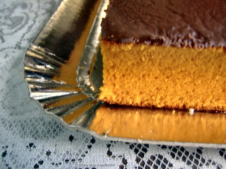 a cake is on a tray with a metal fork