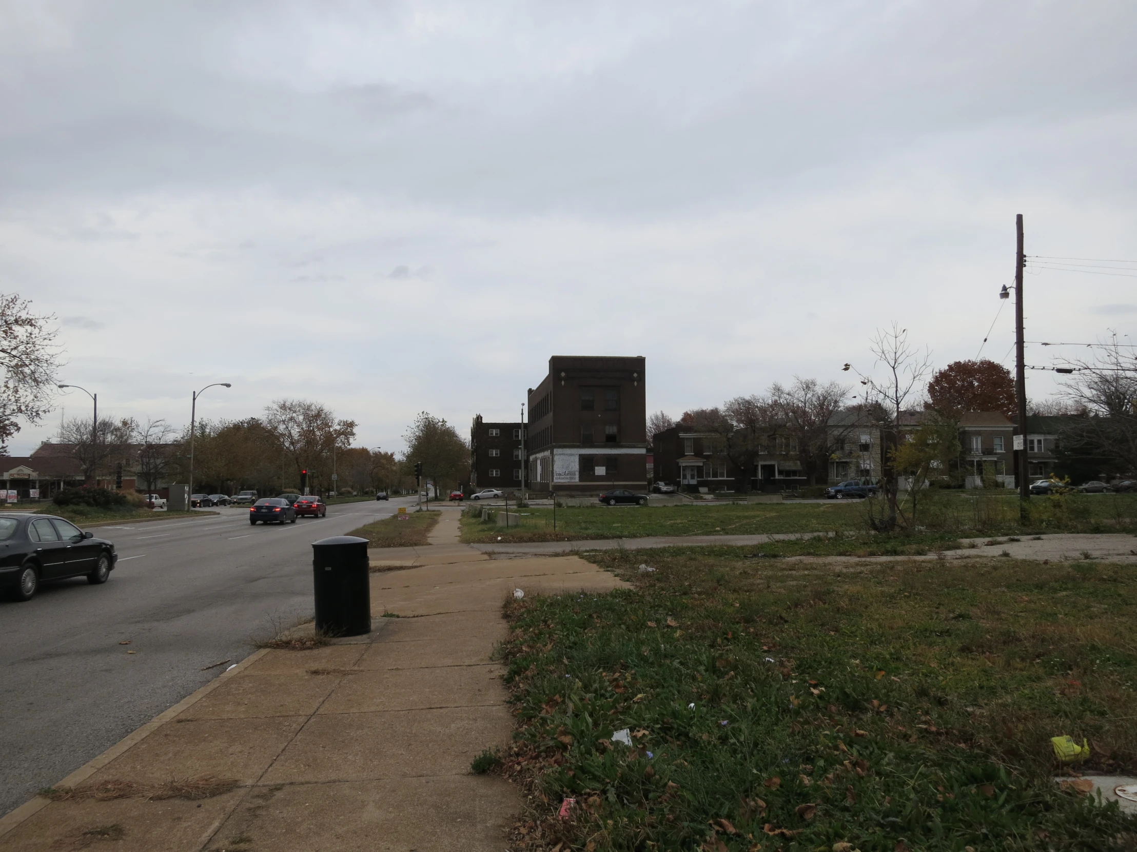 a street with a grassy field next to it