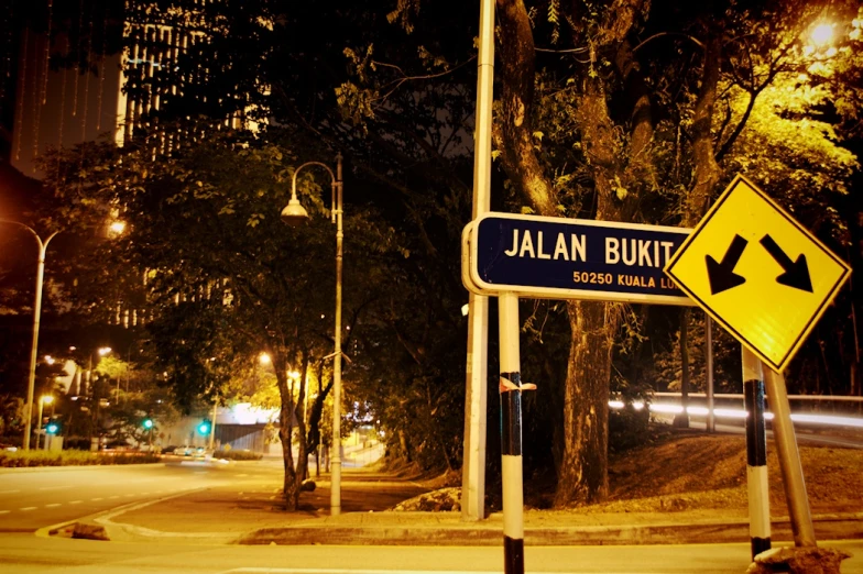 street sign on the corner with an illuminated road in background