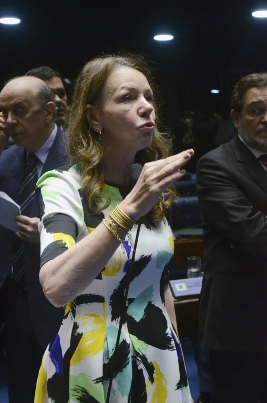 a woman standing with her hand raised up