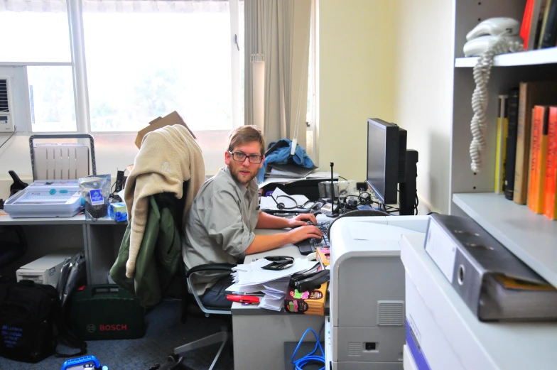 a man in an office workstation on a computer