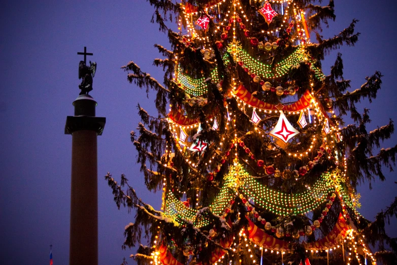 a giant tree decorated with christmas lights and decorations