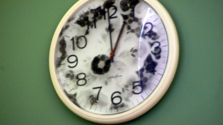 a close up of a clock with black numbers